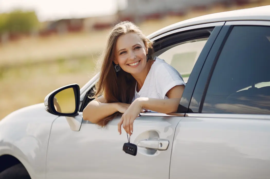 Smiling student in car